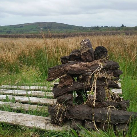 Stack of turf in Edenmore Bog with Cairn Hill in background in North Longford