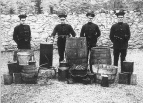 Police with a siezed still in Inisowen - dad and Willie Carty used to run one in sheds while leaving a ribbish worm and paraphanalia in a field to be "found" by customs men, and a few bottles for themselves to keep them quiet!